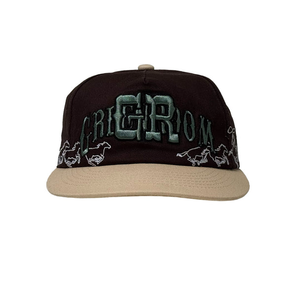 Black and beige cap with embroidered text and horse designs on a white background
